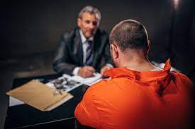 A detective interviewing a prisoner on a table